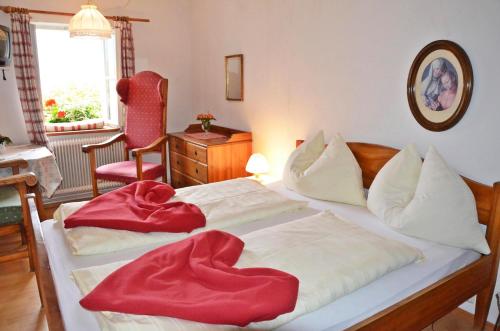 a bedroom with two beds with red blankets on them at Bräugasthof Hallstatt in Hallstatt
