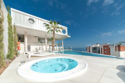 a large pool with a hot tub on the side of a building at Med Love Story in Fuengirola