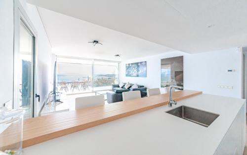 a kitchen and living room with a view of the ocean at Med Love Story in Fuengirola
