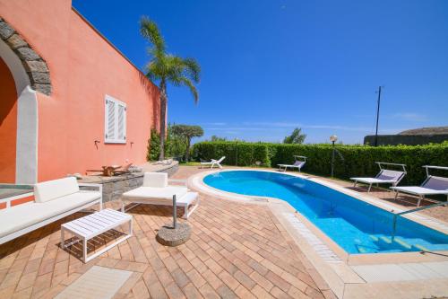 a house with a swimming pool next to a building at Villa Stefania in Ischia