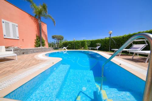 a swimming pool with a water slide in front of a house at Villa Stefania in Ischia