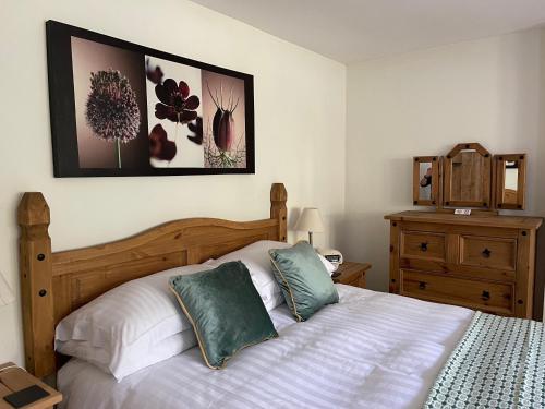 a bedroom with a bed with two pillows on it at Cosy 2 Bedroom Cottage in Betws y Coed, Snowdonia in Betws-y-coed