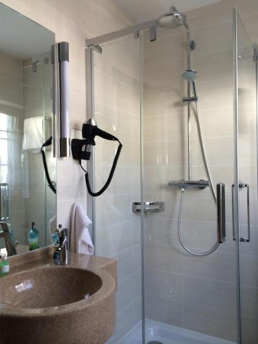 a bathroom with a sink and a shower at Hotel-Restaurant Walkmühle in Usingen