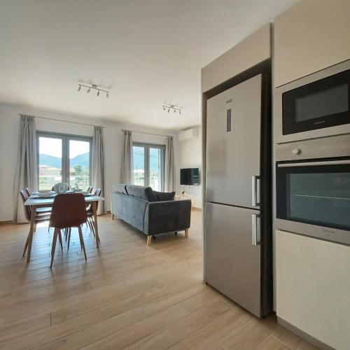 a kitchen and living room with a table and a couch at Anesi View Apartment in Vasiliki