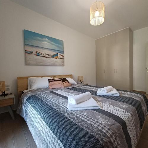 a bedroom with a large bed with towels on it at Anesi View Apartment in Vasiliki