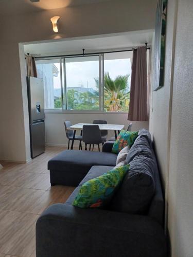 a living room with a couch and a table at Résidence MARINA 3 in Les Trois-Îlets