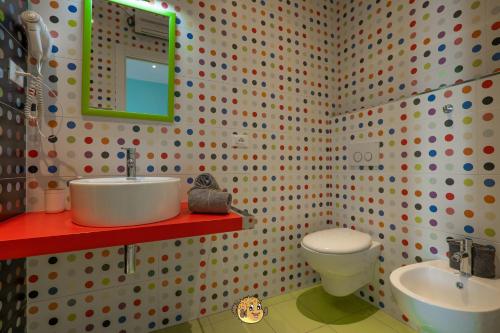 a bathroom with a white toilet and a sink at Pesce Palla Affittacamere in Finale Ligure