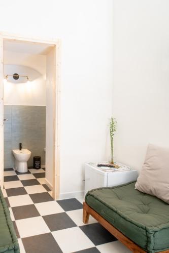 a living room with a couch and a floor at A Calata Rooms in Noto