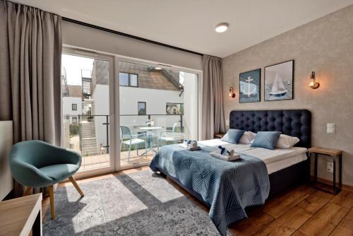 a bedroom with a bed and a large window at Aparthotel Anchoria BlueApart in Mechelinki