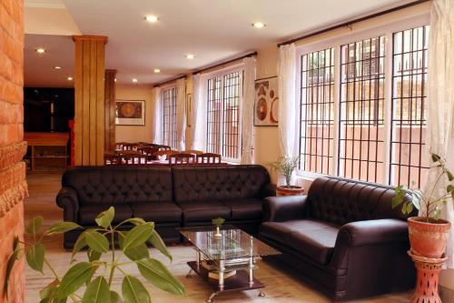 a living room with a couch and a table at Cascade Hotel in Kathmandu