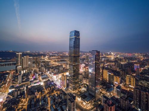 a view of a city at night with a tall skyscraper at Niccolo Changsha in Changsha