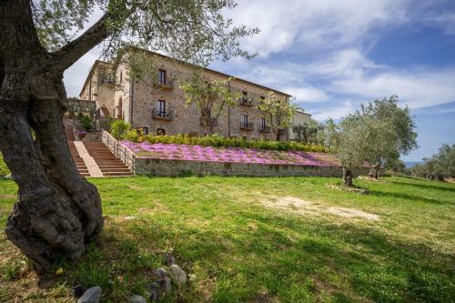 a building with pink flowers on the side of it at Tenuta Ciminata Greco in Rossano
