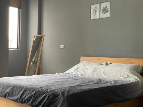 a bed in a bedroom with a picture on the wall at Hello Guesthouse in Lugang
