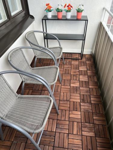 two chairs and a table on a staircase with plants at Kemi CITY III near snowcastle, premium 2 rooms , kitchen , glazed balcony, FREE private parking in Kemi