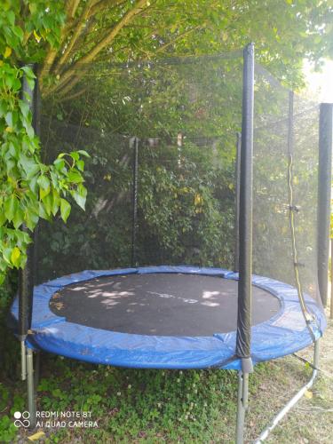 a small trampoline in front of a fence at Le Paillier d'Etienne. in La Cresse