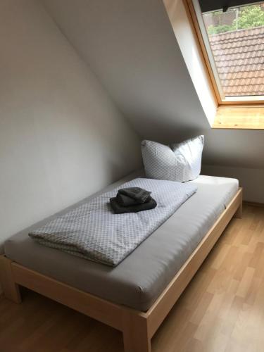 a bed sitting in a room with a window at EZ im Haus Maja in Holzkirchen