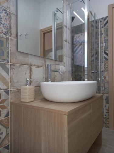 a bathroom with a white sink and a mirror at Donsanto Casa Vacanze in Taormina