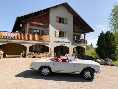 a white car parked in front of a house at le chalet de Plainpalais in Les Déserts