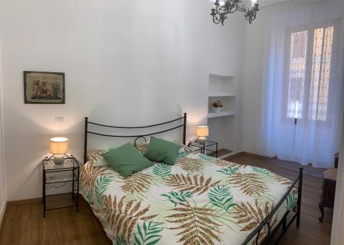 a bedroom with a bed with green and white sheets at Circus Maximus n.2 - At 400m Metro in Rome