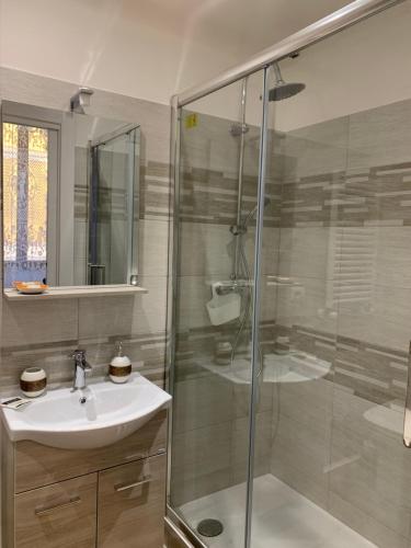 a bathroom with a glass shower and a sink at Circus Maximus n.2 - At 400m Metro in Rome