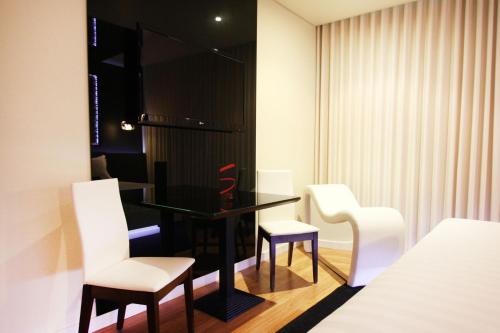 Ένα ή περισσότερα κρεβάτια σε δωμάτιο στο Silk Motel