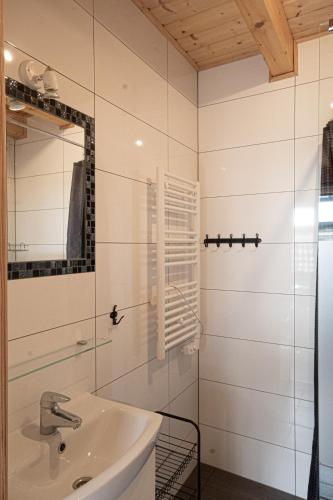 a bathroom with a sink and a mirror at Domki i Apartamenty Al Mare in Sianozety