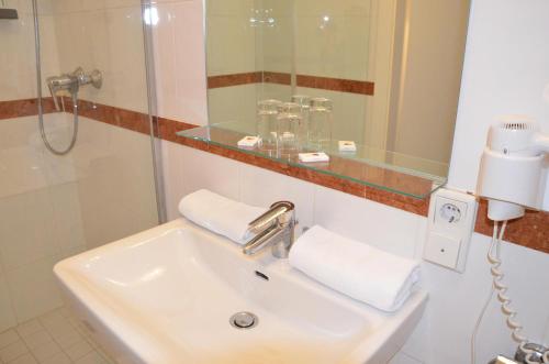 a bathroom with a sink and a mirror at Seehotel Schlick in Fuschl am See