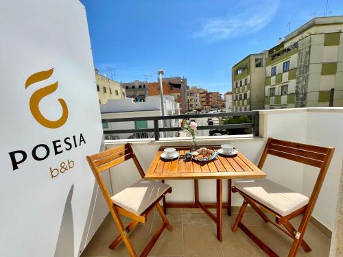 a table and chairs on a balcony with a sign at B&B Poesia in Gallipoli