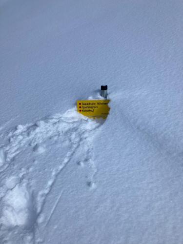 a yellow object sticking out of the snow at Haus Asslaber in Hochfilzen