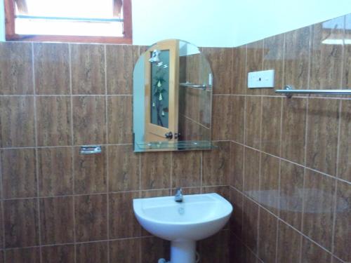 a bathroom with a sink and a mirror at Tissa Resort in Tissamaharama