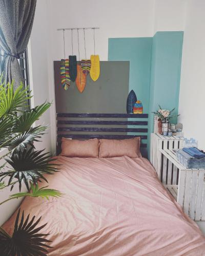 a bedroom with a bed with a wooden head board at LILY HOUSE( Mini home 2PN) in Quy Nhon