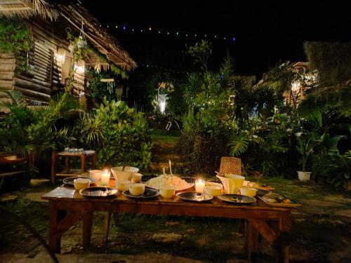 a wooden table with candles on top of it at Payag n' Kapitan, Experience pinubre living in Siquijor