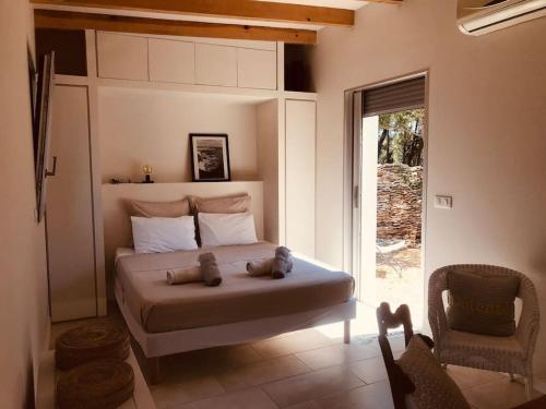 une chambre avec un lit avec deux ours en peluche dessus dans l'établissement Petite Bergerie, à Bonifacio