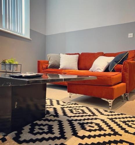a living room with a couch and a coffee table at The Law House By The Opulence - Free City Centre Parking in Bradford