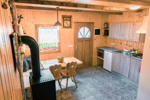 a kitchen with a stove and a table in it at Počitniška hiška Jrga in Bovec