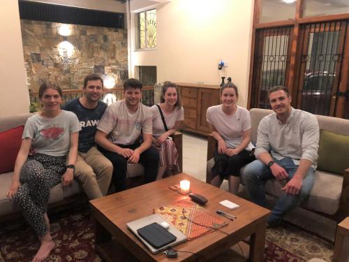a group of people sitting around a coffee table at Hansons Homestay in Kandy