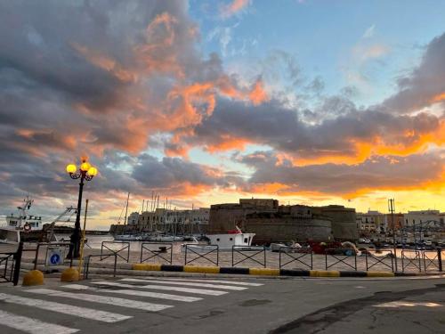 a view of a harbor with a cloudy sky at B&B Poesia in Gallipoli