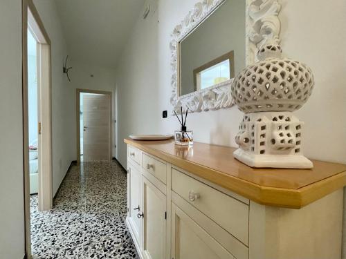 a room with a counter with a mirror on the wall at B&B Poesia in Gallipoli
