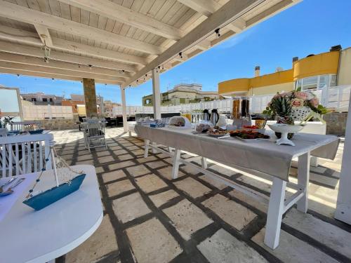 a patio with a table with food on it at B&B Poesia in Gallipoli