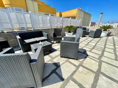 a group of chairs and tables on a patio at B&B Poesia in Gallipoli