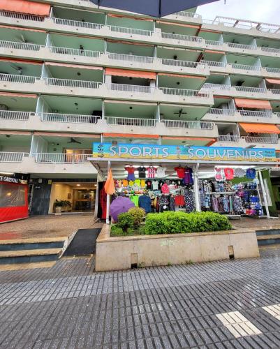 a store in front of a large building at SALOU FAMILY APARTMENT in Salou