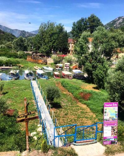 a bunch of boats are parked in a field at Apartments FLORA and boat cruising in Virpazar