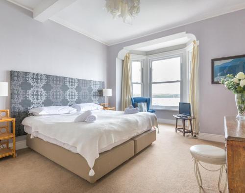 a bedroom with a large bed and a window at The Terrace 4 in Padstow