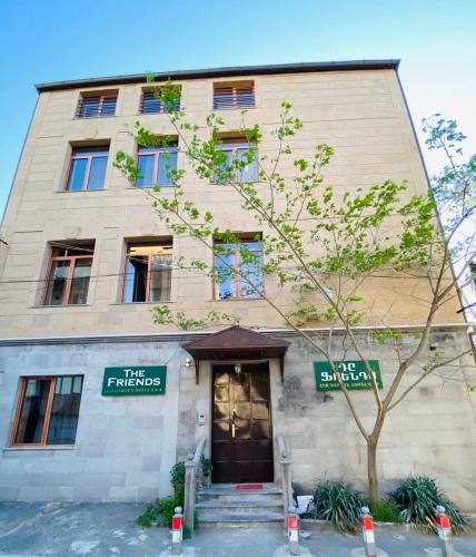 a building with a tree in front of it at The Friends in Yerevan