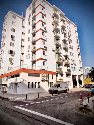 a white building with a van parked in front of it at Newly Renovated Super-Chic Apartment in Nicosia