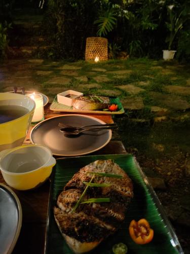 a table with two plates of food on it at Payag n' Kapitan, Experience pinubre living in Siquijor