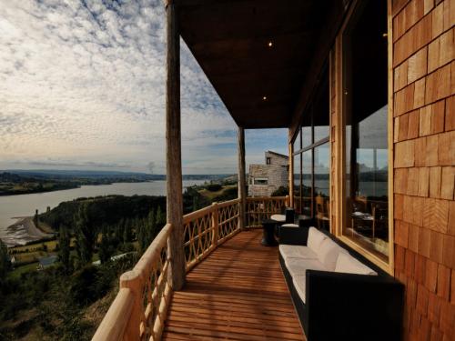 a balcony of a house with a view of a river at OCIO Territorial Hotel in Castro