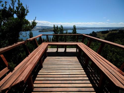 a wooden bridge with a view of a lake at OCIO Territorial Hotel in Castro