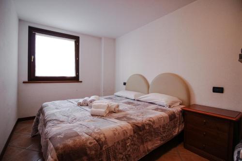 a bedroom with a bed with two pillows on it at Residence Aquila - Bilo Monte Rena in Brusson