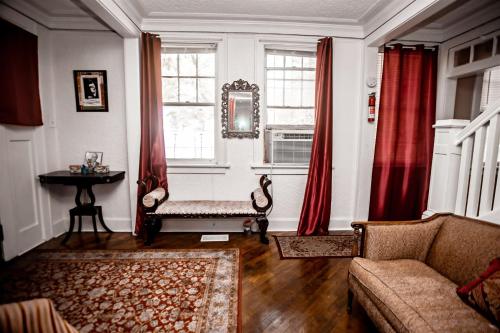 a living room with a couch and a window at Historic House on the HillDownstairs ONLY in Tuskegee